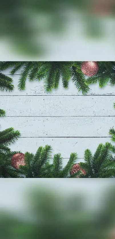 Festive phone wallpaper with pine branches and holiday ornaments.