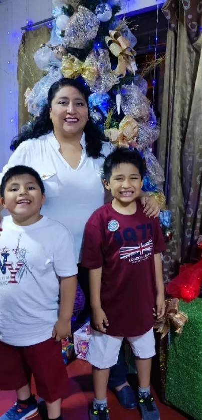 Family posing by a decorated Christmas tree with festive decor.