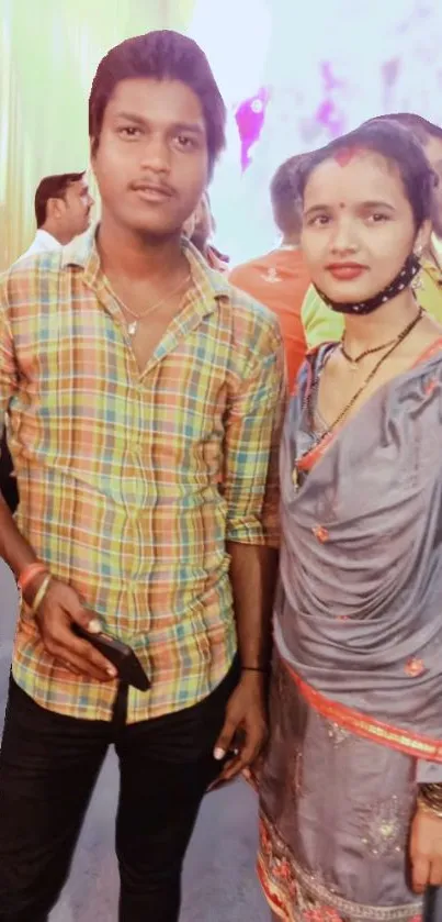 Couple in colorful festive attire posing together.