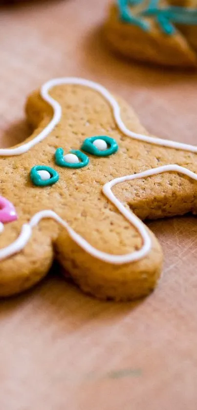 Gingerbread cookie on wooden surface with colorful icing.