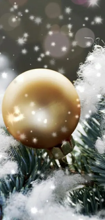 Gold ornament with snow on pine needles.