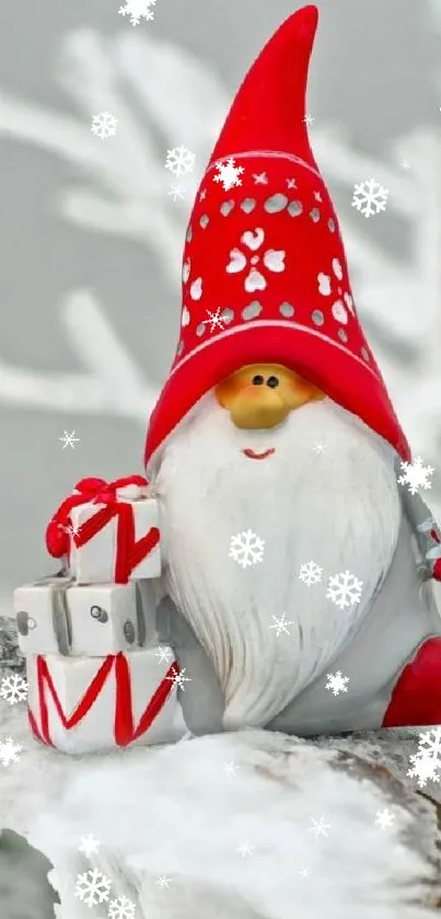 Festive gnome with red hat and gifts on snowy branch wallpaper.