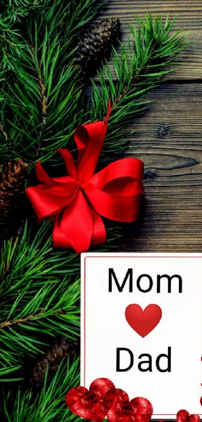 Festive wallpaper with green pine, red bow, hearts, and a card reading 'Mom ❤ Dad'.