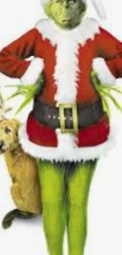 The Grinch in a Santa suit standing with a small dog.