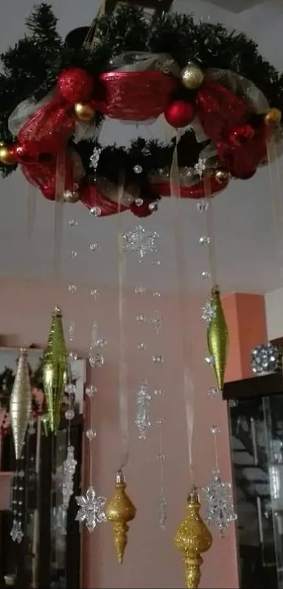 Festive wreath with red and gold ornaments hanging indoors.