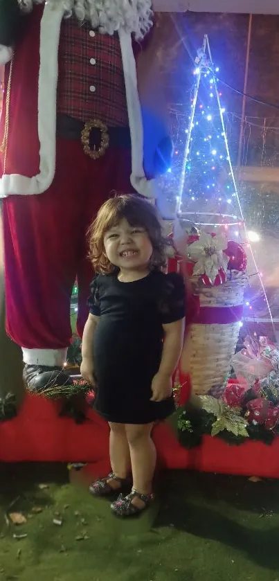 Joyful child beside festive Christmas display.