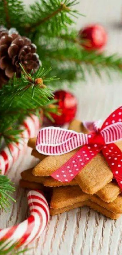 Festive cookies with red ribbon and pine decorations on a wooden table.