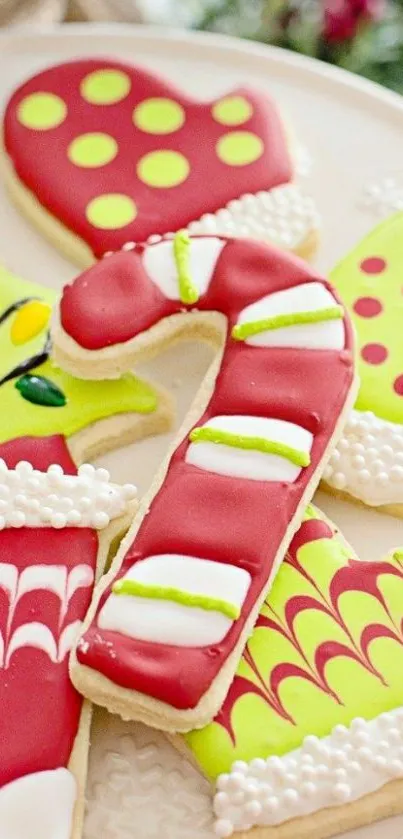 Festive holiday cookies with candy cane and mittens on a plate.