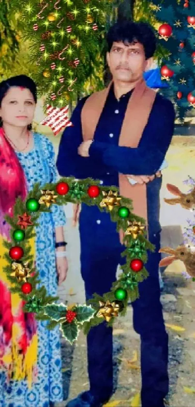 Couple portrait with festive holiday decorations and greenery.