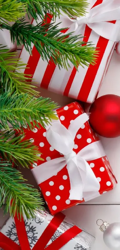 Red and white Christmas gifts with pine branches.