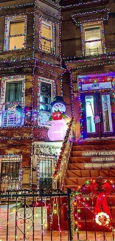 Festively decorated house with bright holiday lights and a snowman.