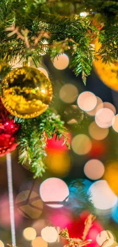 Christmas tree branches with festive ornaments and bokeh lights.