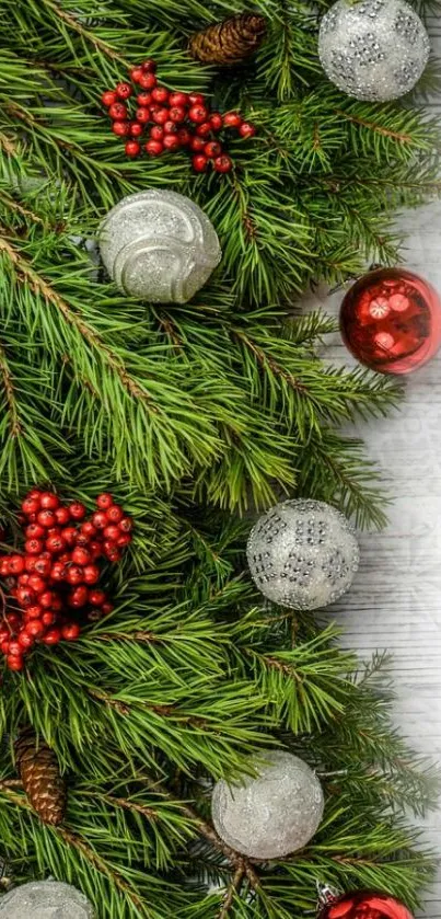 Festive pine branches with red berries and ornaments