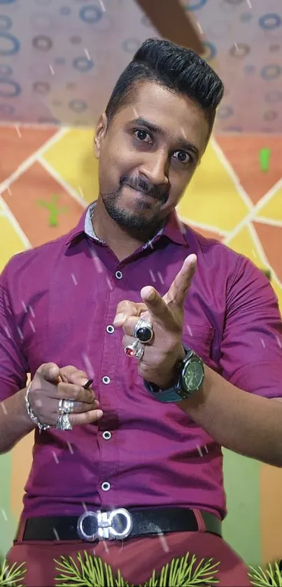 Man in magenta shirt with festive background.