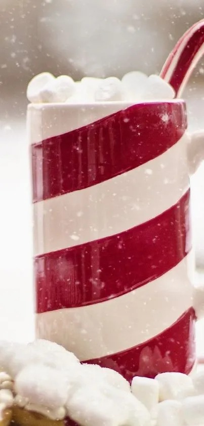 Festive mug with candy cane, marshmallows, and cookies on a snowy background.