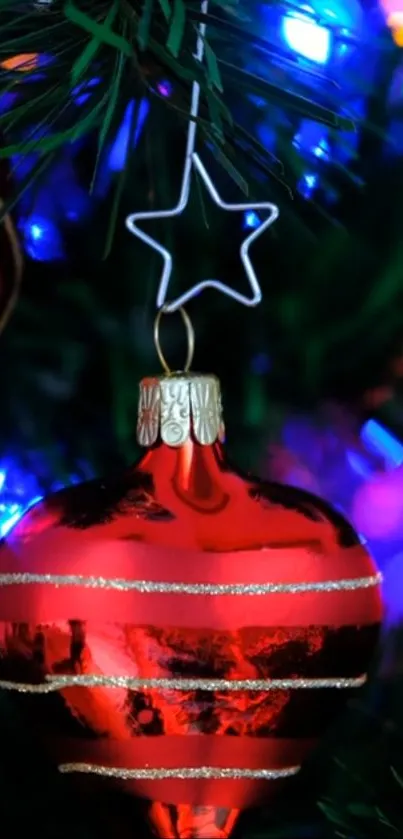 Shiny red Christmas ornament on a vibrant tree with colorful lights.