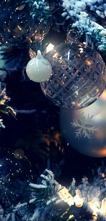 Glowing Christmas ornaments in snowy tree.