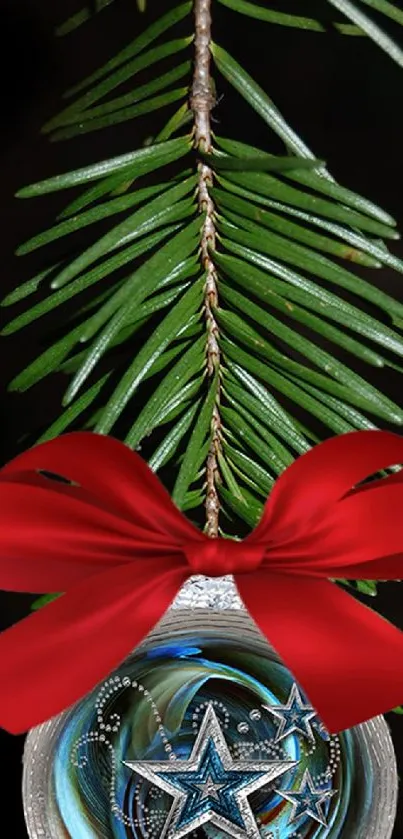 Decorative Christmas ornament on evergreen branch with red ribbon.