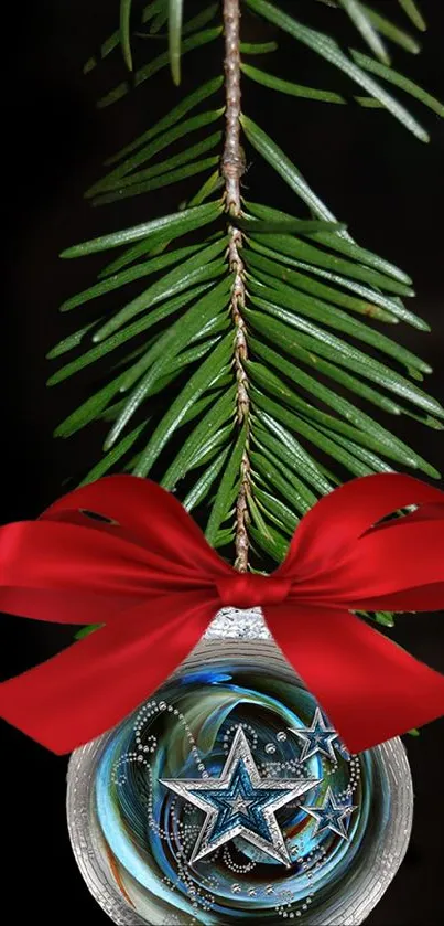 Festive ornament with red bow and pine branch on dark background.