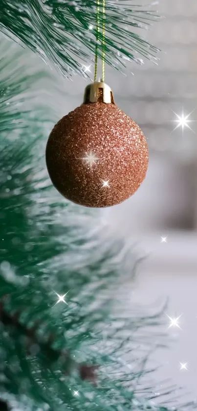 Sparkling bauble on green pine with festive decor.