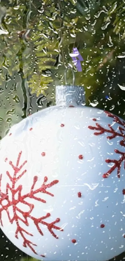 Festive Christmas ornament with raindrops on mobile wallpaper.