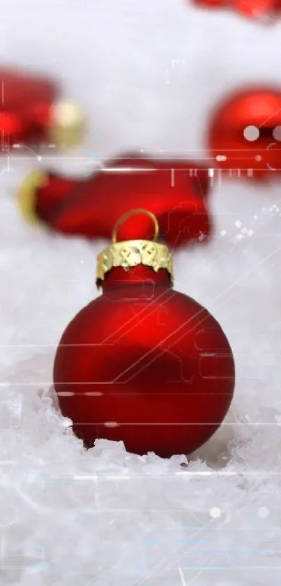 Red ornaments and lit candles on a snowy background.