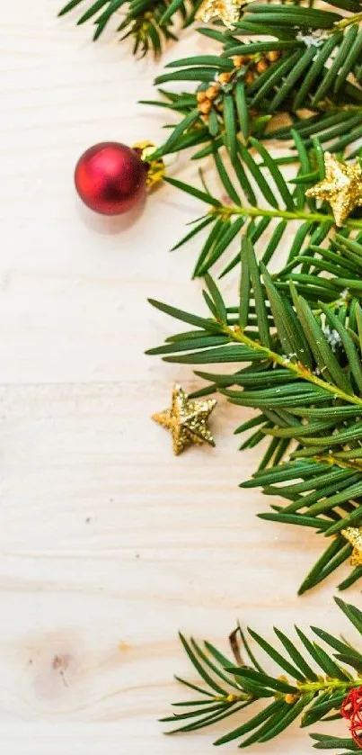 Festive wallpaper with pine branches and golden stars on a wooden background.