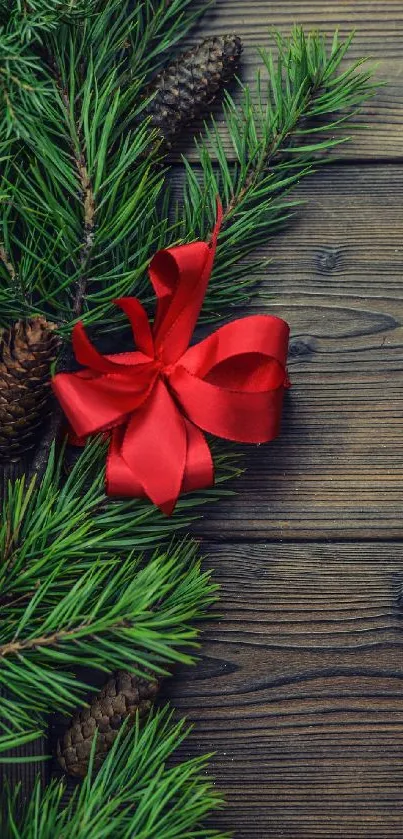 Festive mobile wallpaper with pine, red bow, and wooden texture.