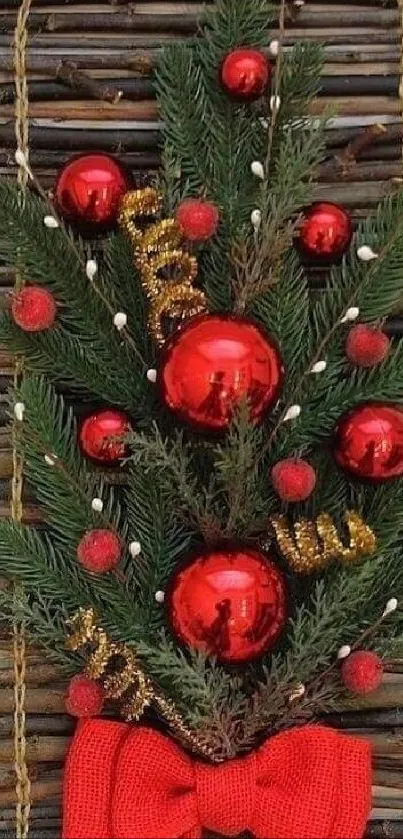 Festive wall decoration with pine, red ornaments, and ribbon.