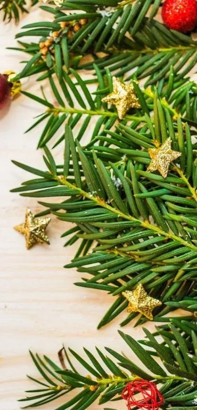 Christmas wallpaper with pine branches, gold stars, and red ornaments.