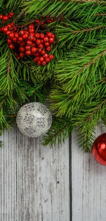 Festive Christmas mobile wallpaper with pine branches and baubles.