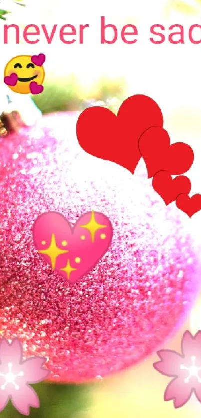 Festive pink ornament with heart emojis and bokeh lights.