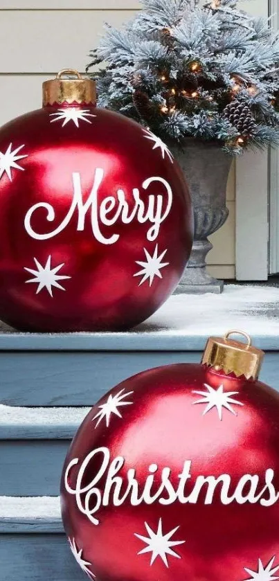 Festive red Christmas ornaments on snowy steps with decorations.