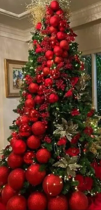 Vibrant Christmas tree with red ornaments indoors.