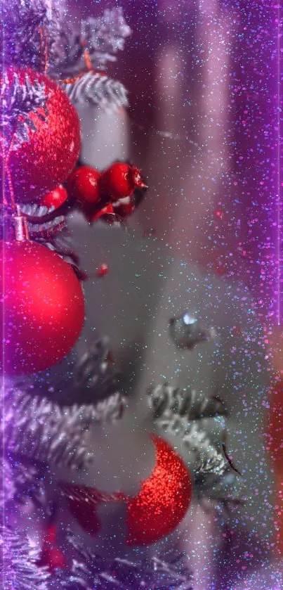Vibrant red Christmas baubles with sparkling purple lights on a festive tree.