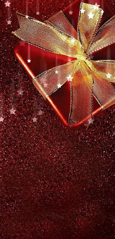 Red glittery background with a gift box wrapped in a gold ribbon.