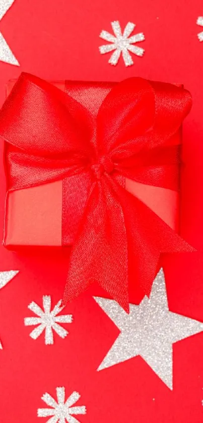 Festive red gift box with silver stars on red background.