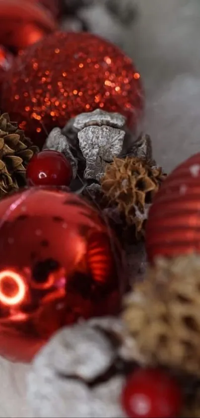 Festive mobile wallpaper with red ornaments and pinecones.