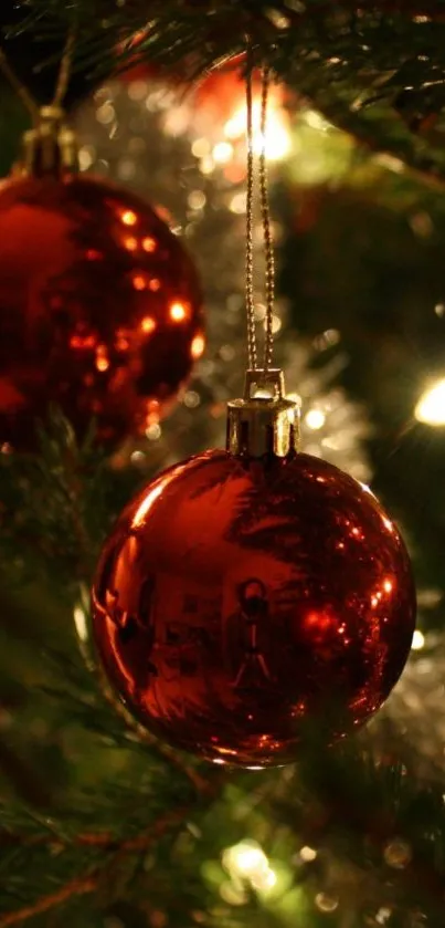 Red Christmas ornament on festive tree, glowing lights background.