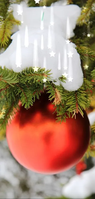 Red ornament on snowy pine branch wallpaper.