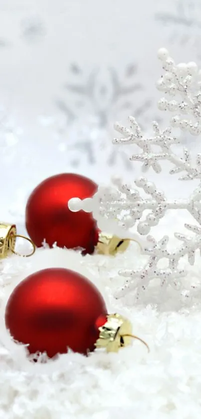 Red Christmas ornaments and white snowflakes for a festive mobile wallpaper.