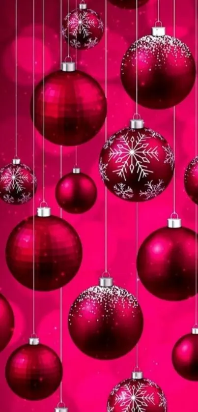 Red Christmas ornaments on a pink background.