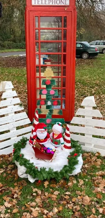 Red phone booth with festive Christmas decor and autumn leaves