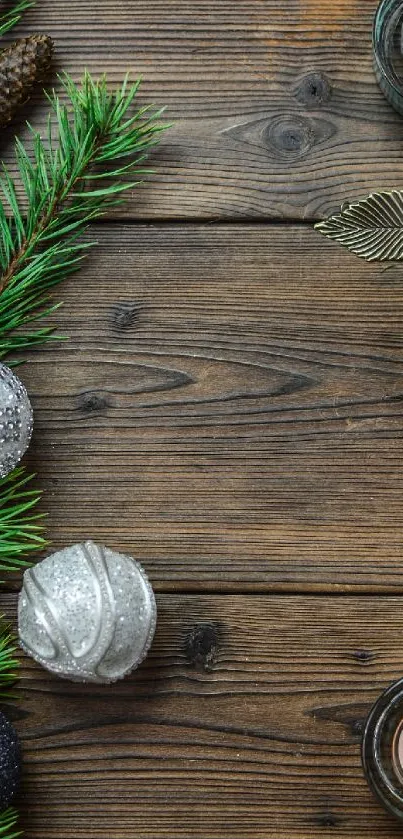 Rustic holiday decor with candles and pine branches on a wooden table.