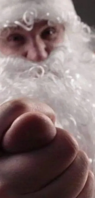 Close-up of Santa Claus fist in festive wallpaper.