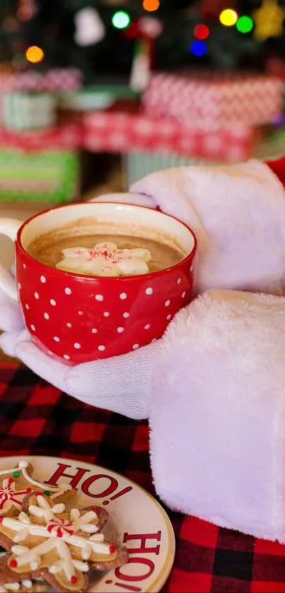 Santa holding red mug with cocoa and cookies on plate.