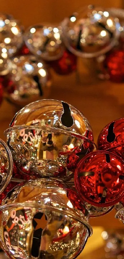 Festive wreath of silver and red bells with wooden background.