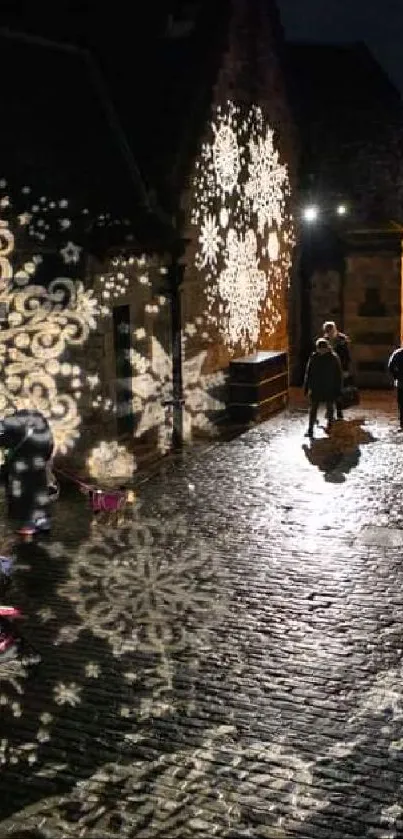 Festive night street with snowflake projections and walking crowd.