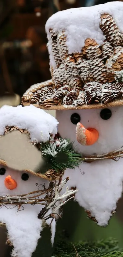 Festive snowman decoration with snow and pine cones in winter setting.