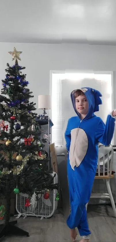 Child in Sonic costume beside decorated Christmas tree.